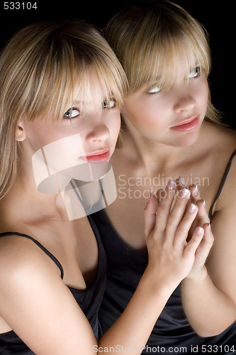 Image of Young beautiful blonde and her reflection in a mirror