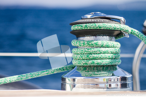 Image of Winch with rope on sailing boat.