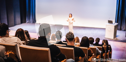 Image of Woman giving presentation on business conference event.