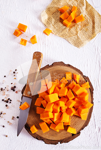 Image of raw pumpkin cubes on board