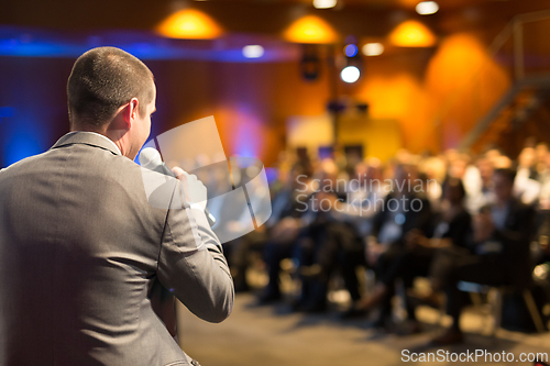 Image of Public speaker giving talk at Business Event.