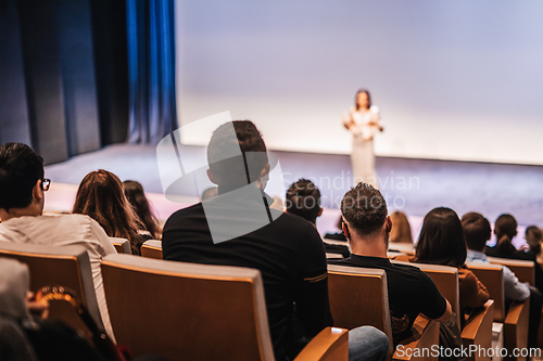 Image of Woman giving presentation on business conference event.