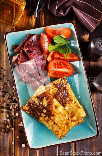 Image of Omelette rolls with ham and cheese. Healthy breakfast.