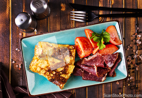 Image of Omelette rolls with ham and cheese. Healthy breakfast.