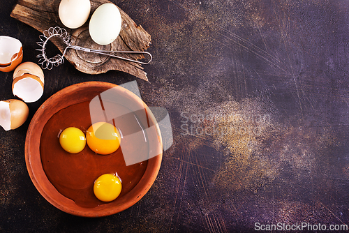 Image of Raw chicken eggs on dark table