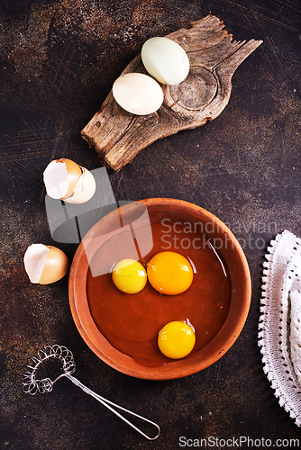 Image of Raw chicken eggs on dark table