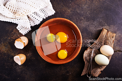 Image of Raw chicken eggs on dark table