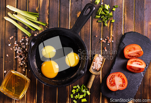 Image of Raw chicken eggs on dark table