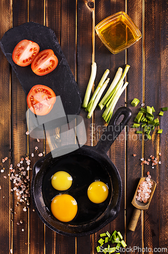 Image of Raw chicken eggs on dark table
