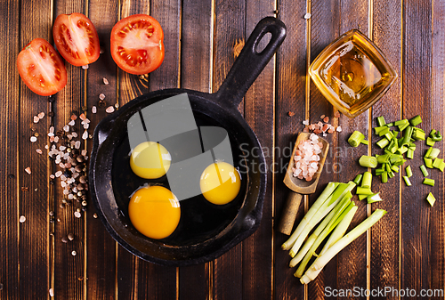 Image of Raw chicken eggs on dark table