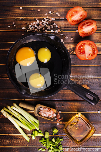 Image of Raw chicken eggs on dark table
