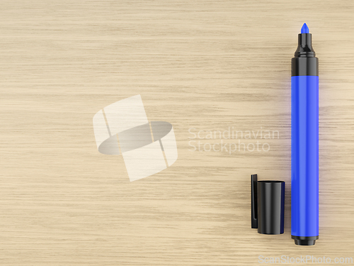 Image of Blue permanent marker on wooden desk