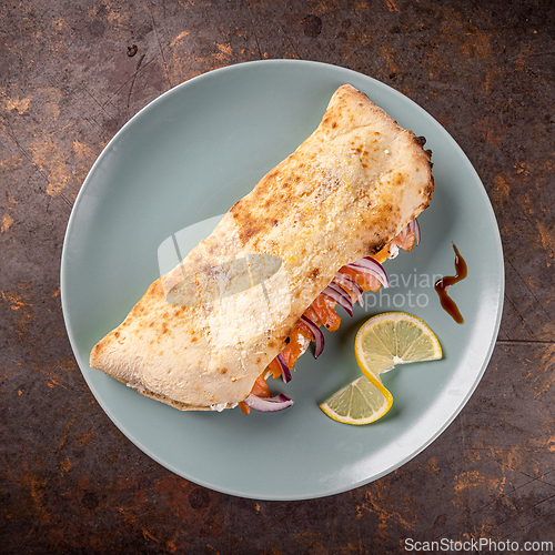 Image of Closed calzone pizza with smoked salmon