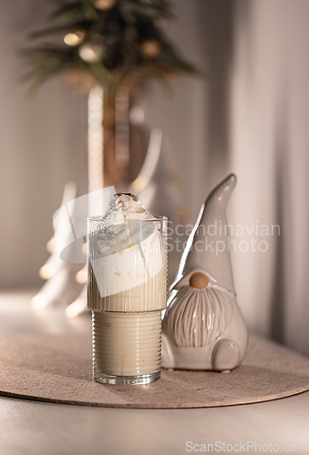 Image of Christmas eggnog cocktail with gingerbread man cookie