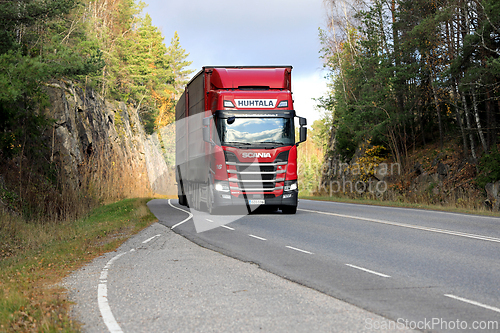 Image of Red Scania 560R Truck Transports Goods on Road