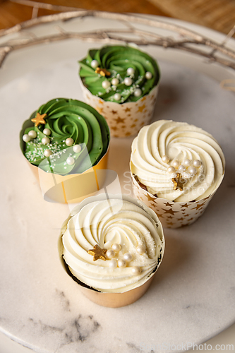 Image of Four cupcakes decorated with gold stars