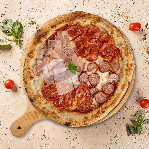 Image of Delicious pizza with ham and sausages 