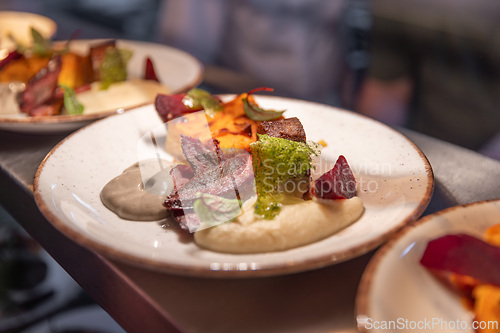 Image of Restaurant kitchen plating elegant gourmet dishes
