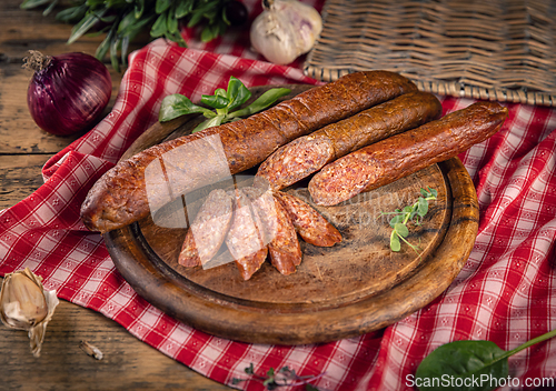Image of Sliced sausage on wooden board