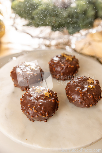 Image of Four chocolate cakes covered with nuts