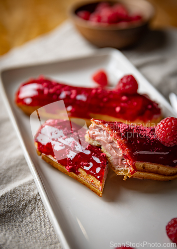 Image of Raspberry eclairs with red raspberry icing