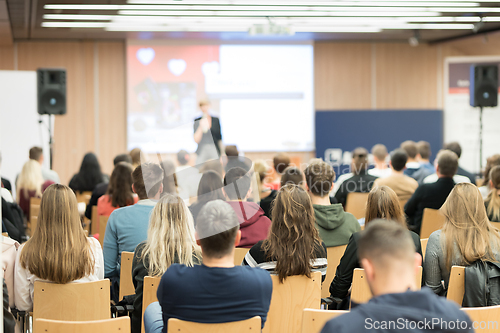 Image of Female speaker giving presentation on business conference.