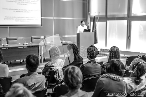 Image of Woman giving presentation in lecture hall at university.