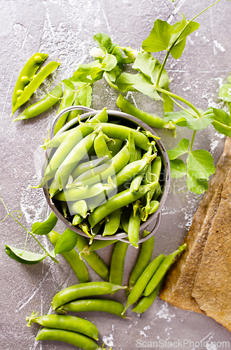 Image of Pods of green peas with leaves. Fresh food background. Top view