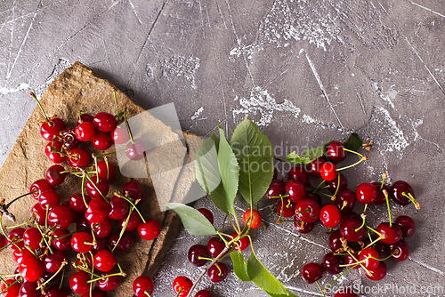 Image of Sweet cherry on stone tray on a table