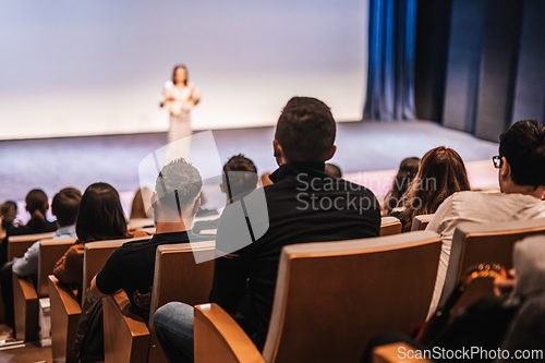 Image of Woman giving presentation on business conference event.