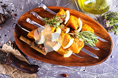 Image of raw kebab with vegetables. On a stone background
