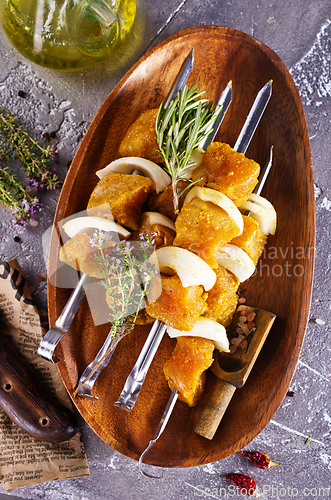 Image of raw kebab with vegetables. On a stone background
