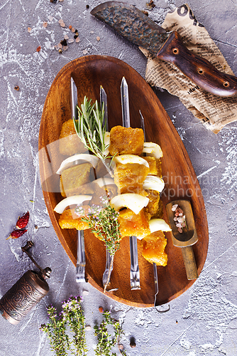 Image of raw kebab with vegetables. On a stone background