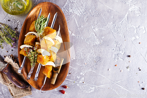 Image of raw kebab with vegetables. On a stone background