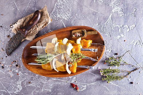 Image of raw kebab with vegetables. On a stone background