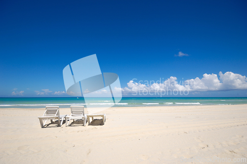 Image of sunbeds and costline  at tropical beach