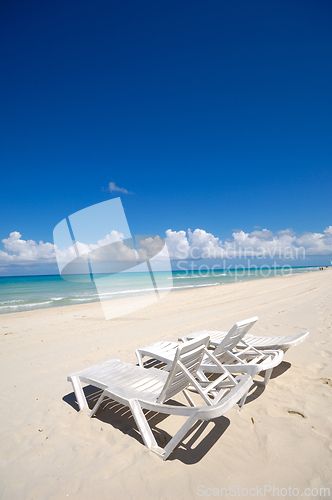 Image of sunbeds and costline  at tropical beach