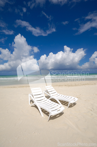 Image of sunbeds and costline  at tropical beach