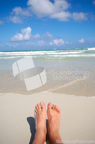 Image of Feet and costline at tropical beach