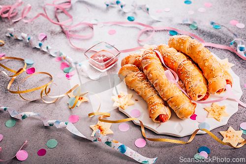 Image of Long sausages wrapped in yeast dough - traditional carnival, Fasching and party food, Pigs in a blanket