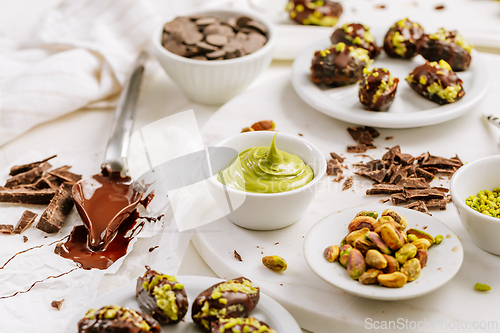 Image of Preparing exquisite dessert, dates filled with pistachio mousse, alternative to popular Dubai chocolate bar