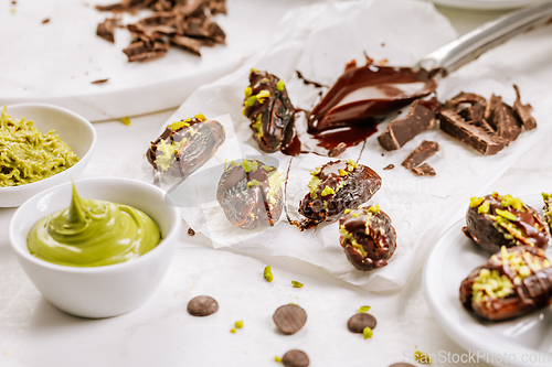 Image of Preparing exquisite dessert, dates filled with pistachio mousse, alternative to popular Dubai chocolate bar
