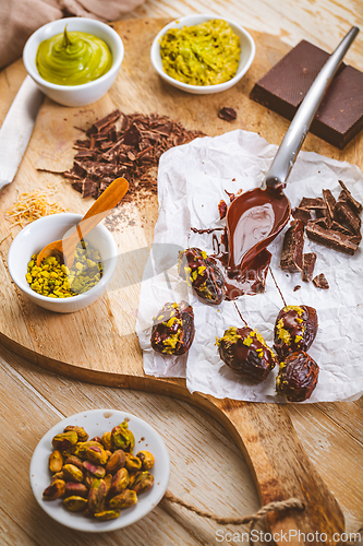 Image of Preparing exquisite dessert, dates filled with pistachio mousse, alternative to popular Dubai chocolate bar