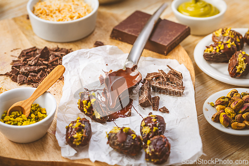 Image of Preparing exquisite dessert, dates filled with pistachio mousse, alternative to popular Dubai chocolate bar