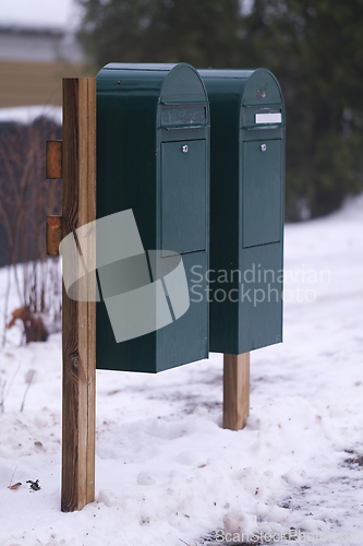 Image of Green mail boxes in winter