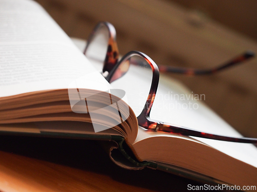 Image of Open book with reading glasses