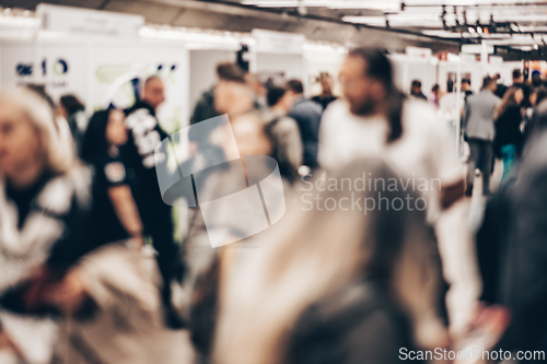 Image of Abstract blurred people at exhibition hall of expo event trade show. Business convention show or job fair. Business concept background.