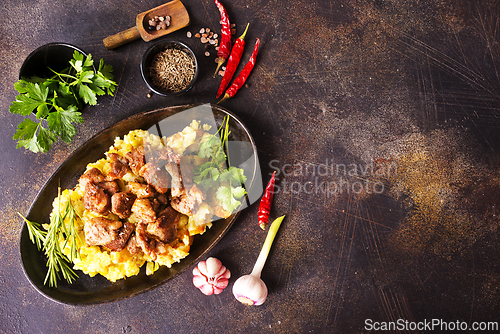 Image of Meat with prunes, goulash and mashed potatoes