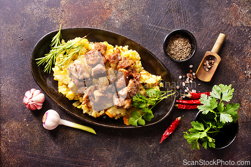 Image of Meat with prunes, goulash and mashed potatoes