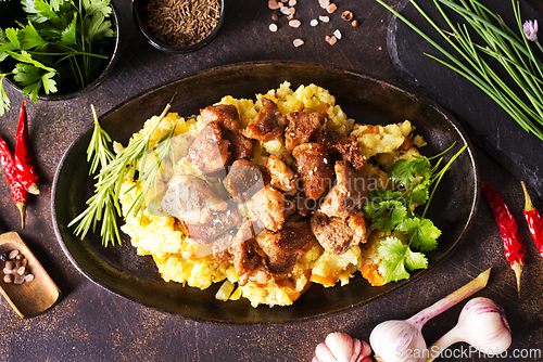 Image of Meat with prunes, goulash and mashed potatoes